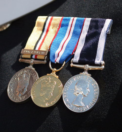 Three military medals displayed on the chest on a British soldier